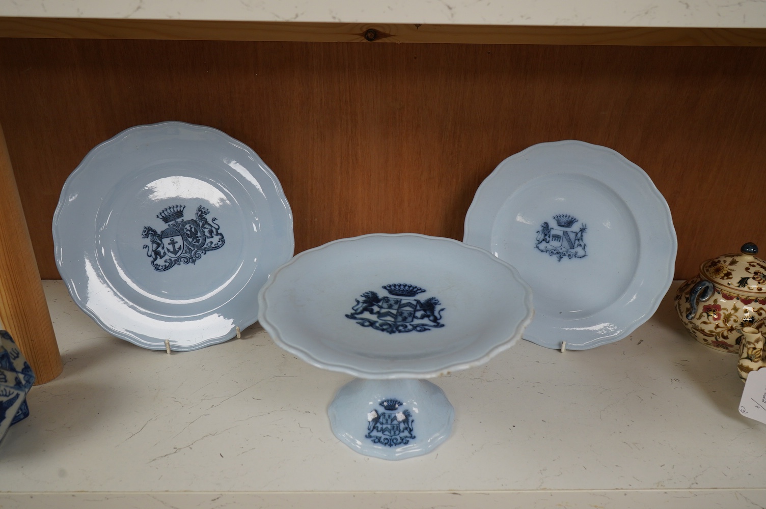 A Victorian Brown Westhead & Moore blue comport and two similar armorial plates, 23cm in diameter (3). Condition - good